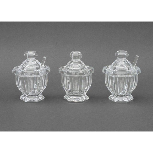 Collection of Seven Baccarat Crystal Tableware Pieces, comprising: three covered mustard pots, two with spoons, and four...