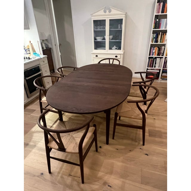 Hans Wegner CH337 table with one extension leaf and six CH24 chairs, all in smoked oil and oak. Purchased from Carl Hansen...