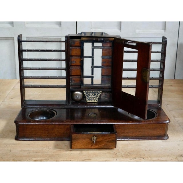 A rare victorian oak cox's patent till, with brass fittings, and inset with a brass plaque cox’s patent, fitted with...