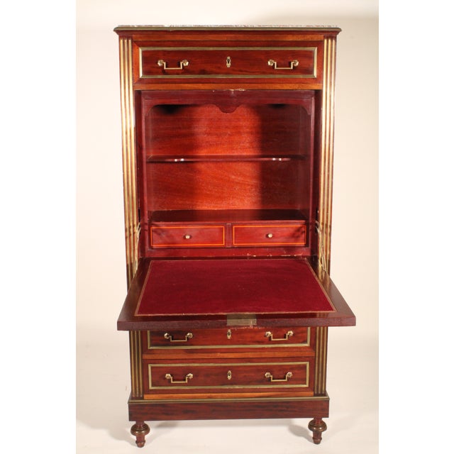 Antique Louis XVI style brass mounted mahogany secretaire abattant, circa 1920's. With a marble top, a top drawer, the...