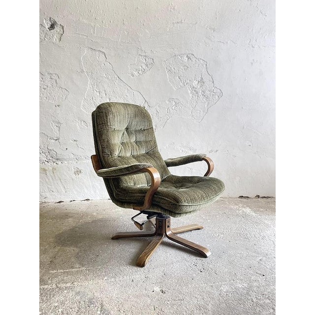 An authentic and exceptionally comfortable 1970s Scandinavian swivel lounge chair — a fine example of the classic...
