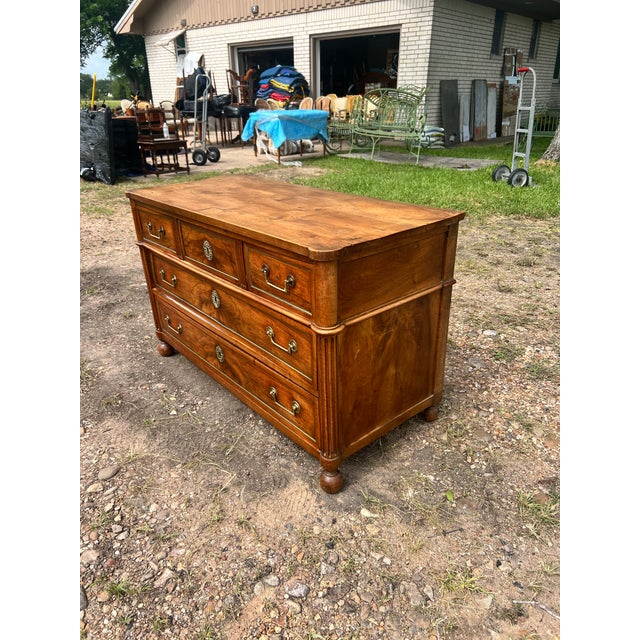 An elegant 19th-century French Louis XVI commode, beautifully crafted in richly figured walnut with striking bookmatched...