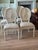 Solid oak. Hand carved rosette. Fluted leg. Woven cane back rest. Upholstered seat. Linen. 40” h. 18 3/4” seat. 18” seat...