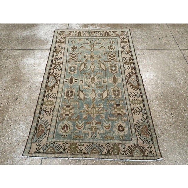 This Mid-20th century Persian Malayer rug, measuring 3' 4" x 5' 7", is a fine example of the village weaving traditions...