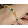 this is an amazing bracelet with yellow sapphire : 6.00 carats emerald : 2.60 carats gold : 10.290 gms