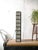 A long stage batten by siemens with eight lamp positions, each behind a white reflector cup, and a hinged black wire...