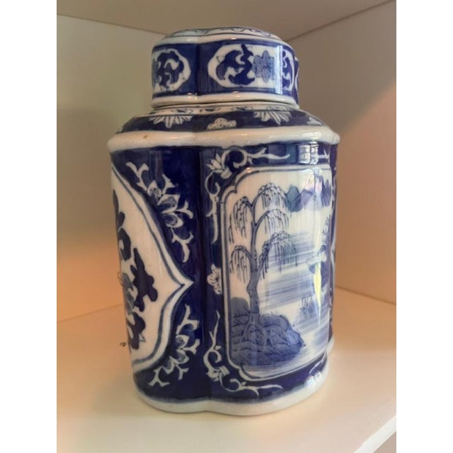 This is a lidded ginger jar featuring traditional blue and white Chinoiserie motifs. The design typically includes...