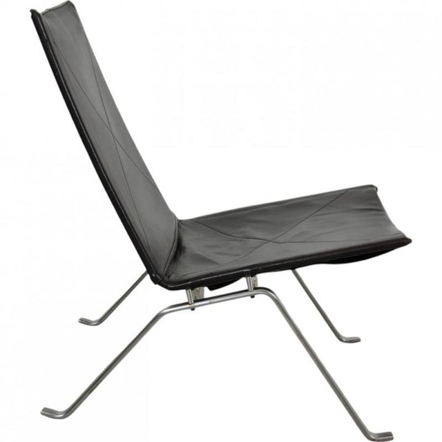 Poul Kjærholm PK-22 lounge chair upholstered in the original brown leather, and with a frame of steel. The chair is from...