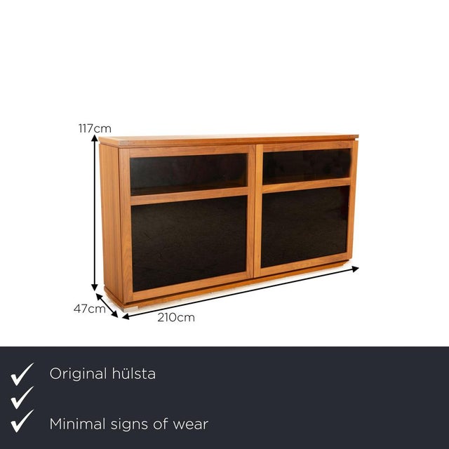 The Lanum sideboard from Hülsta is made of brown wood and is floor-level. The rustic design sets it apart. I have official...