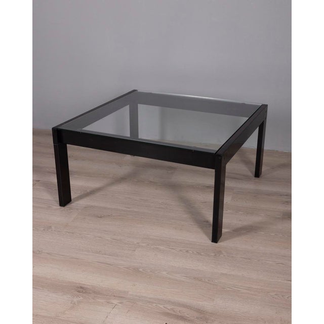 Square coffee table with black steel frame and clear glass top, "Sanmarco" model, designed by Gae Aulenti for Zanotta,...