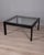 Square coffee table with black steel frame and clear glass top, "Sanmarco" model, designed by Gae Aulenti for Zanotta,...