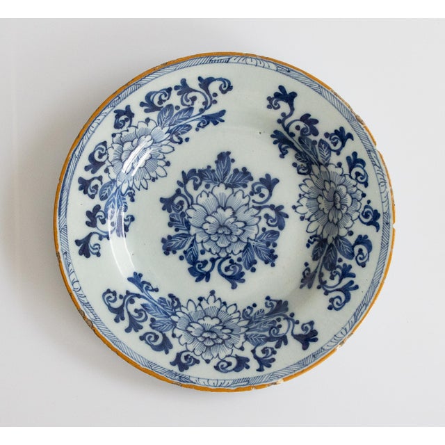 A pair of lovely antique 18th-Century Dutch Delft faience hand painted floral plates in vibrant cobalt blue and white with...