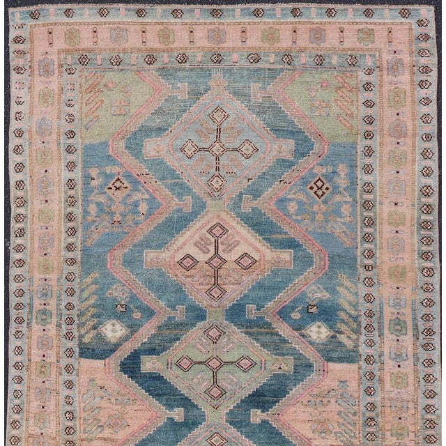 Measures: 4'8 x 10'1. This antique Persian Kurdish rug has been hand-knotted in wool and features an all-over, Sub-...