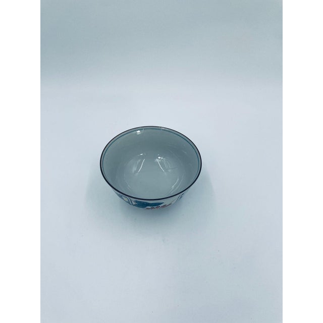 A traditional Japanese rice bowl in the Arita style, crafted from high-quality porcelain. The bowl features a classic,...
