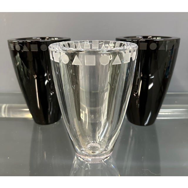 A striking set of three etched crystal vases designed by Ward Bennett for Sasaki, Japan. The grouping features two in deep...
