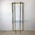 This vintage modern étagère features a tall, sculptural brass frame paired with a clear glass shelf, creating a refined...