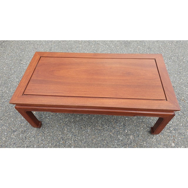 An exquisite Mid 20th Century Ming Style Rosewood cocktail Table with protective Glass Top. Pristine vintage condition...