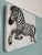 Hand-painted, glazed terracotta bas-relief. Depicts a zebra. Wall decoration. The work is signed.