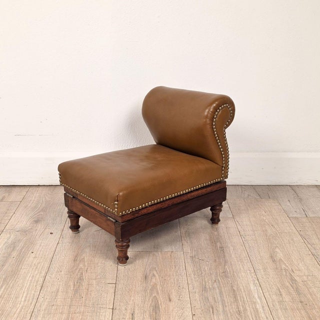 A Victorian/Edwardian adjustable gout stool, made of mahogany and upholstered in leather.