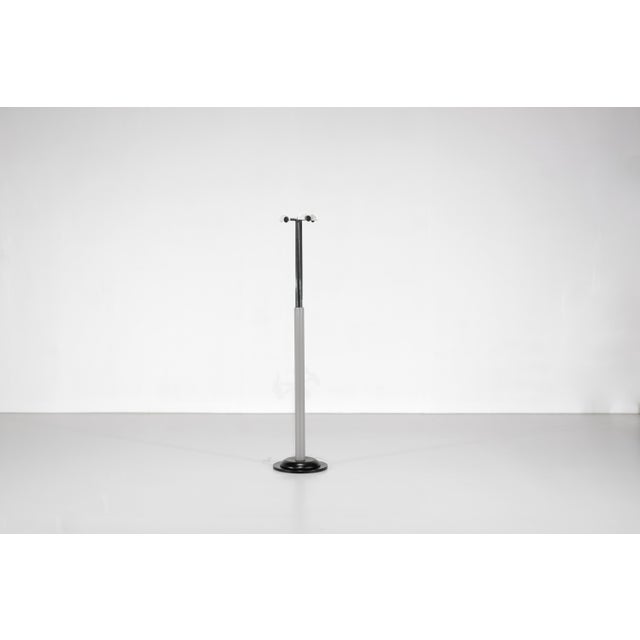 The "Tucano" coat rack consists of a sturdy black metal base and five height-adjustable arms. One of the arms is stuck at...