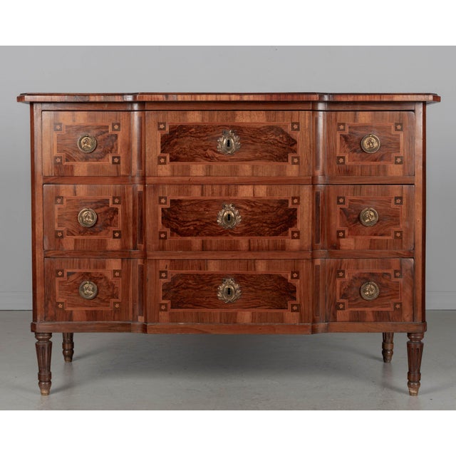 A fine 18th century German Louis XVI style marquetry commode, or chest of drawers, with inlaid veneers of walnut, mahogany...