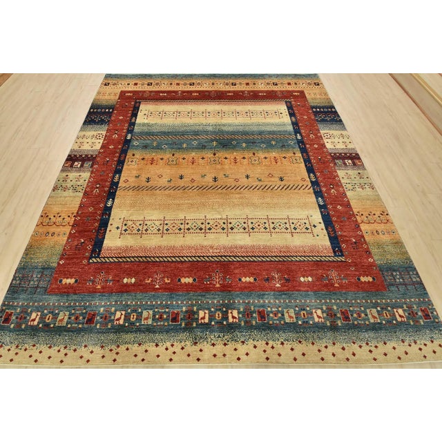 This tribal Gabbeh rug is hand-knotted with an all-wool pile on a cotton foundation. This rug is new and in excellent...