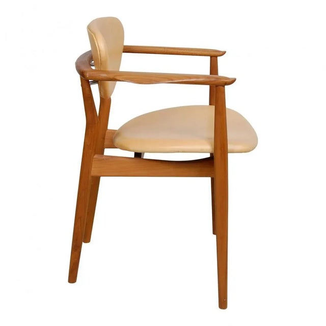 Finn Juhl Armchair model 109 with solid teak frame and natural leather seat and back. The chair is from around the year...