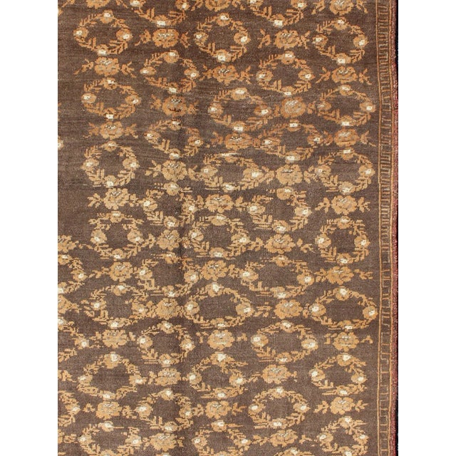 Measures: 4'5 x 7'4 The design of this beautiful vintage Oushak rug from mid-20th century Turkey is enhanced by its...