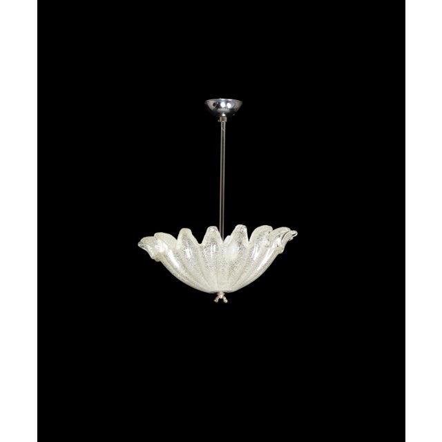 This Art Deco chromed pendant light boasts a translucent Murano style glass shade topped with a designed leaf dome. The...