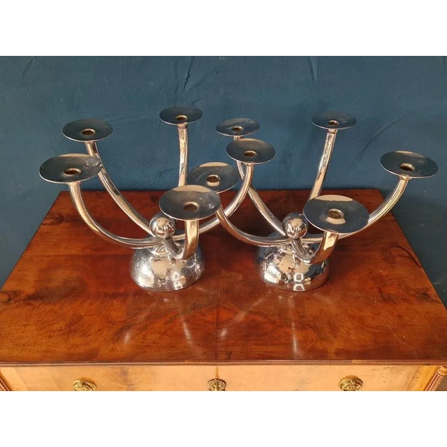 A set consisting of two large candlesticks, made by Wilhelm Schulze for the Bremen workshops for handicraft silver work...