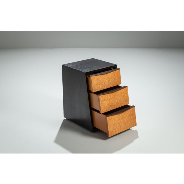 This vintage sloped chest of drawers is a striking example of refined craftsmanship and sculptural form. Constructed from...