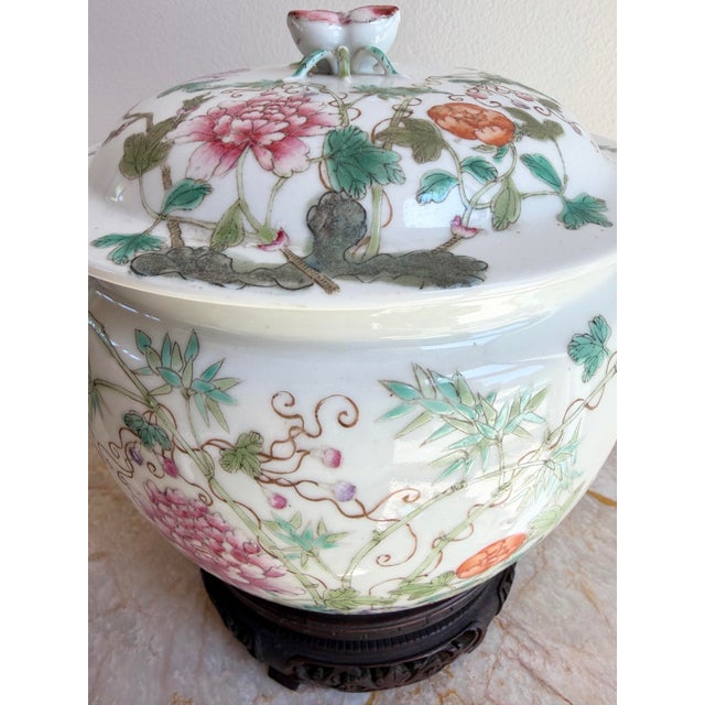 This is a beautiful Antique Chinese Famille Rose (Fencai) Porcelain Lidded Jar with Carved Rosewood Stand. It is in...