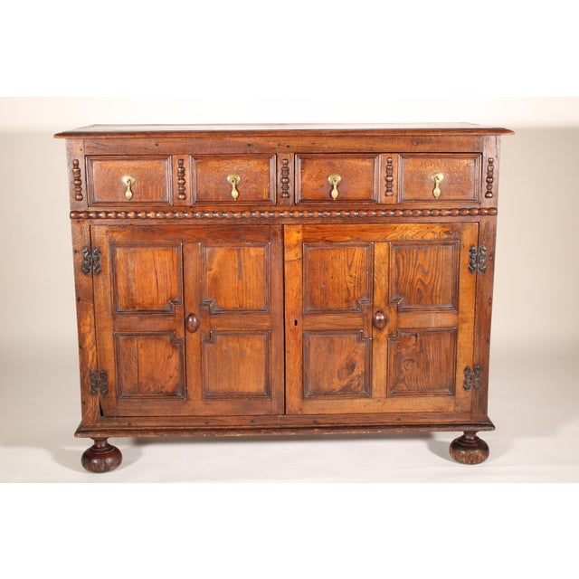 Antique William and Mary / Jacobean transitional style oak cabinet, circa 1900. With a single board oak top with molded...