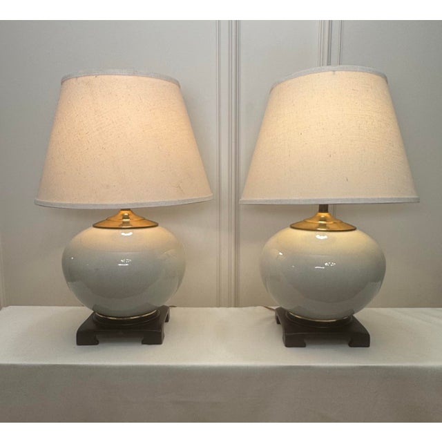 There's a transitional classic minimalism along with subtle Asian inspiration to this pair of table lamps. Each lamp...