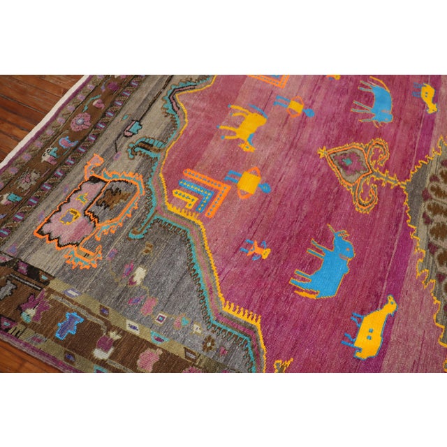 One of a kind whimsical Turkish Animal Human figurative Motif on a fuchsia ground. This rug is from the middle of the 20th...