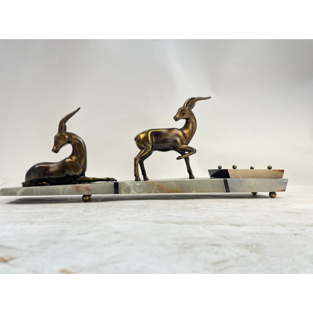 Beautiful 1920s Liberty ornament, made of colored marble and with metal sculpture. Excellent furnishing object