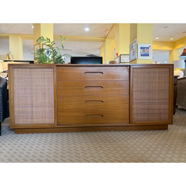 Elevate your space with this stunning mid-century modern mahogany and cane credenza designed by the legendary American...