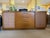 Elevate your space with this stunning mid-century modern mahogany and cane credenza designed by the legendary American...