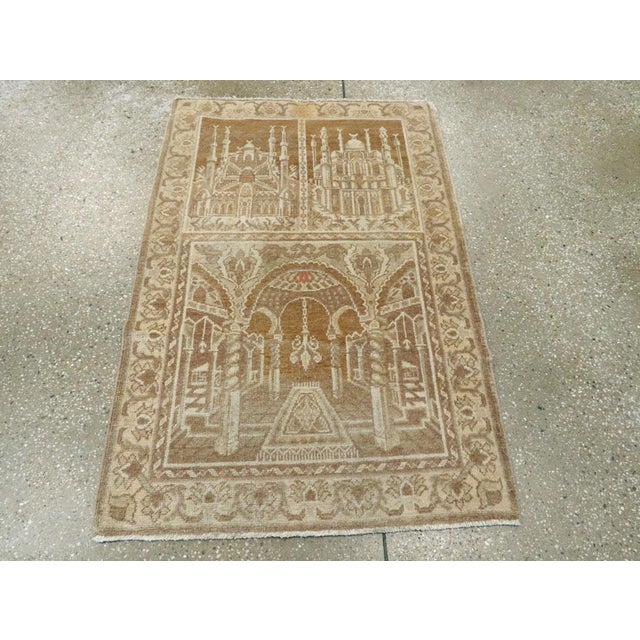 A vintage East Turkestan Khotan Pictorial throw rug. Two distinct mosque exteriors are depicted in the upper field half...