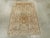A vintage East Turkestan Khotan Pictorial throw rug. Two distinct mosque exteriors are depicted in the upper field half...