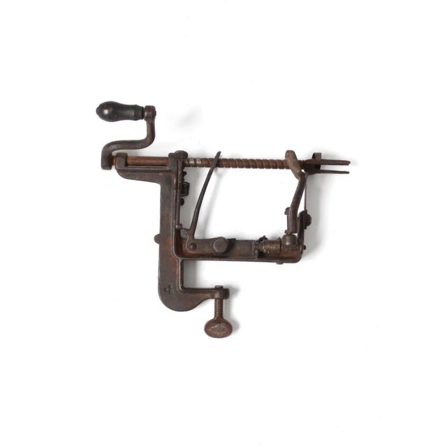 This antique Goodell White Mountain apple parer (#3) features a cast iron corer and peeler with a clamp-on base and...