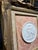 Vintage Italian Souvenir of grand tour Porcelain Medallion on gilded Frame Against a Fortuny Fabric Background.medallion...
