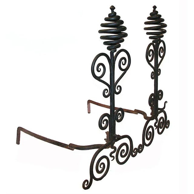 Antique early 20th century hand wrought andirons having scroll and corkscrew motif.