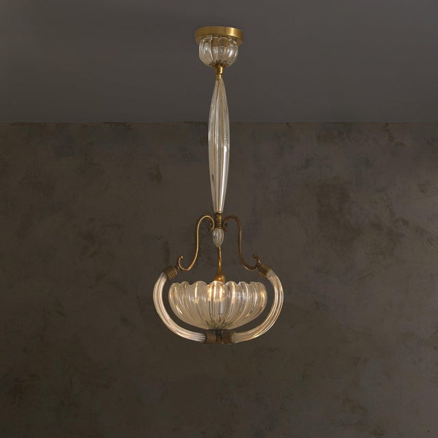 An Italian Murano glass pendant attributed to Barovier & Toso, crafted in the 1940s. A cascade of elongated, fluted glass...