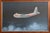 A rare original oil painting of the first US Navy cargo plane built during WW2. Oil on board. Framed in its original wood...