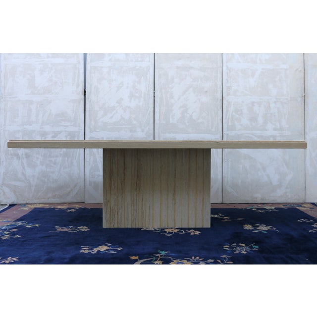 Striking Mid-Century Modern Italian travertine dining table, circa 1970s, featuring a substantial rectangular top...