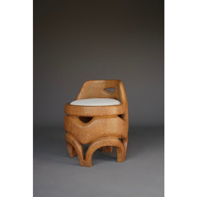 A stylish solid palm wood side chair was purchased by its former owner in the 1970s. It has a drop-in bouclé covered seat.