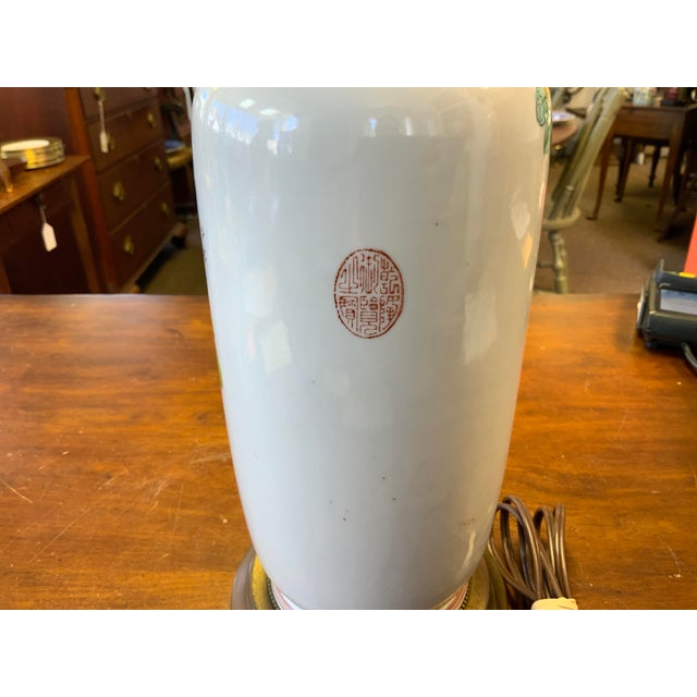 20th century Chinoiserie lamp. Narrow tall shape , with beautiful floral detail. Vintage double light socket with pull...