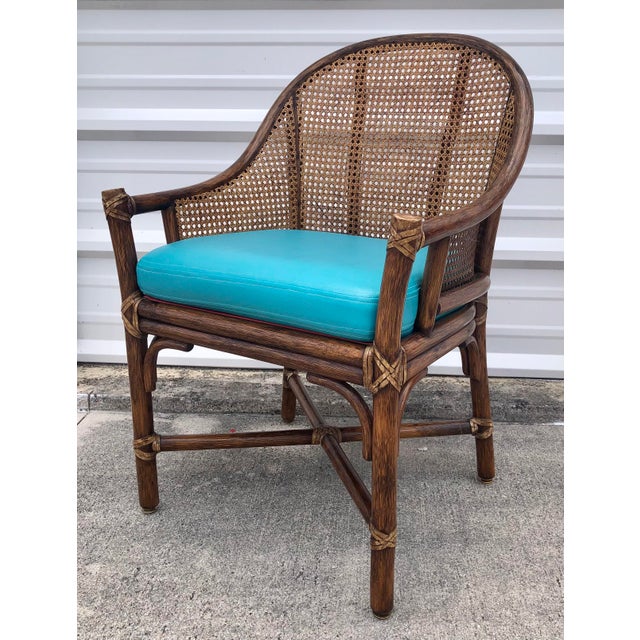 Beautiful vintage mid century McGuire rattan and cane arm chair. Teal leather cushion. Wrapped in leather ties. Rattan and...