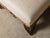 A pair of English Regency period footstools from the 19th century with carved feet, gilded accents and custom upholstery....